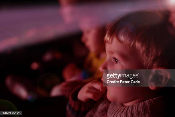 young boy watching film at cinema - film and television screening stockfoto's en -beelden