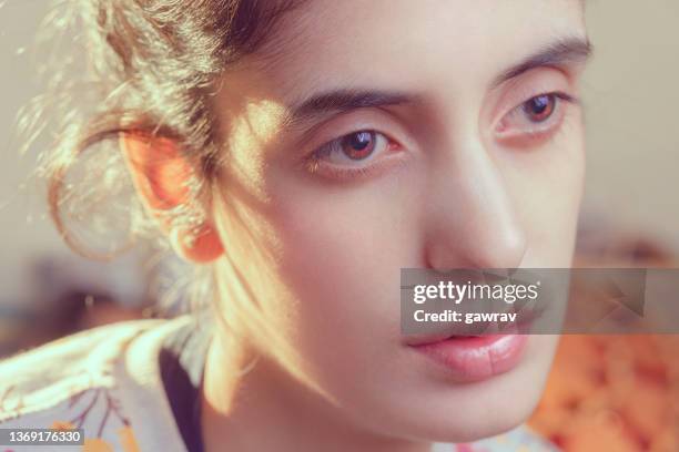 portrait of a young woman contemplates sadly. - lightskinned stock pictures, royalty-free photos & images