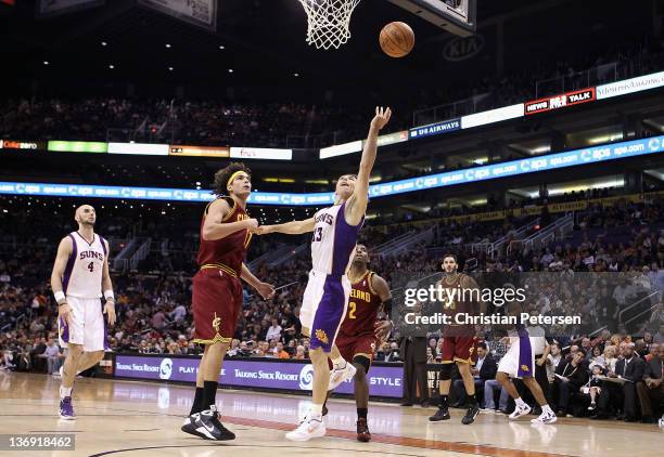 Steve Nash of the Phoenix Suns lays up a shot past Anderson Varejao of the Cleveland Cavaliers during the NBA game at US Airways Center on January...