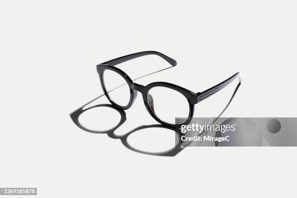 black eyeglasses in silhouette with shadow - reading glasses stock pictures, royalty-free photos & images