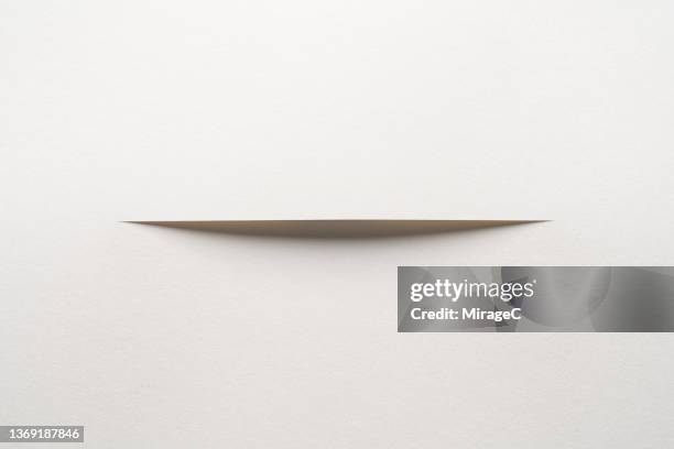 white paper cut in the middle - cutter paper fotografías e imágenes de stock