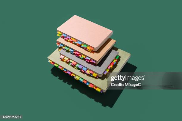 books with colorful bookmarks - textbook stack stock pictures, royalty-free photos & images