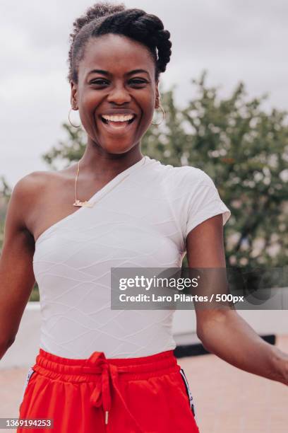 forever happy,portrait of smiling young woman standing outdoors,luanda,angola - editorial photography stock pictures, royalty-free photos & images