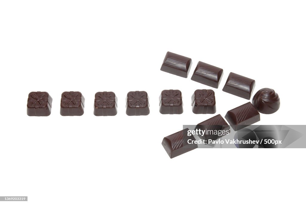 Chocolate arrow,Close-up of chocolates over white background