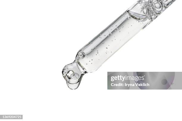 close-up pipette with face serum or essential oil with oxygen aqua bubbles on a white color background, isolated. - pipeta imagens e fotografias de stock