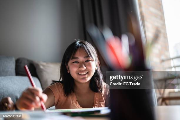 portrait of a teenage girl drawing at home - teen creativity stock pictures, royalty-free photos & images
