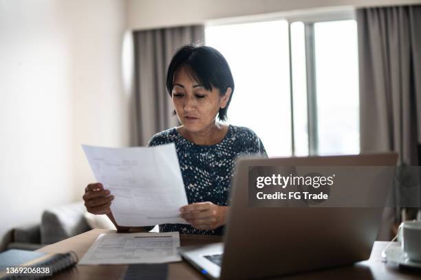 mature woman doing home finances - past due stock pictures, royalty-free photos & images