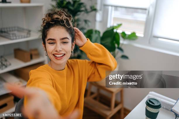 cheerful businesswoman taking selfie with mobile phone in office - sweatshirt imagens e fotografias de stock