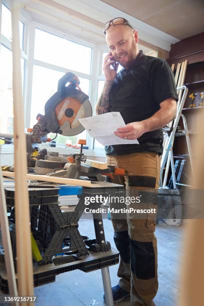 carpenter on the phone - order pad stock pictures, royalty-free photos & images