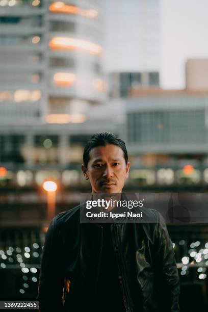 man looking at camera in city at night, tokyo - akihabara stock pictures, royalty-free photos & images