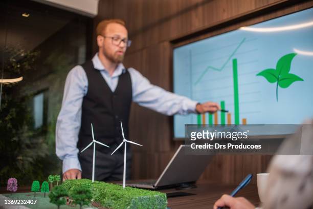 businesspeople talking about renewable energy - environmental issues stock pictures, royalty-free photos & images