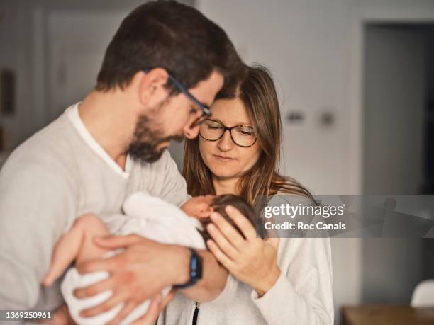 father and mother with their baby - family newborn stock pictures, royalty-free photos & images