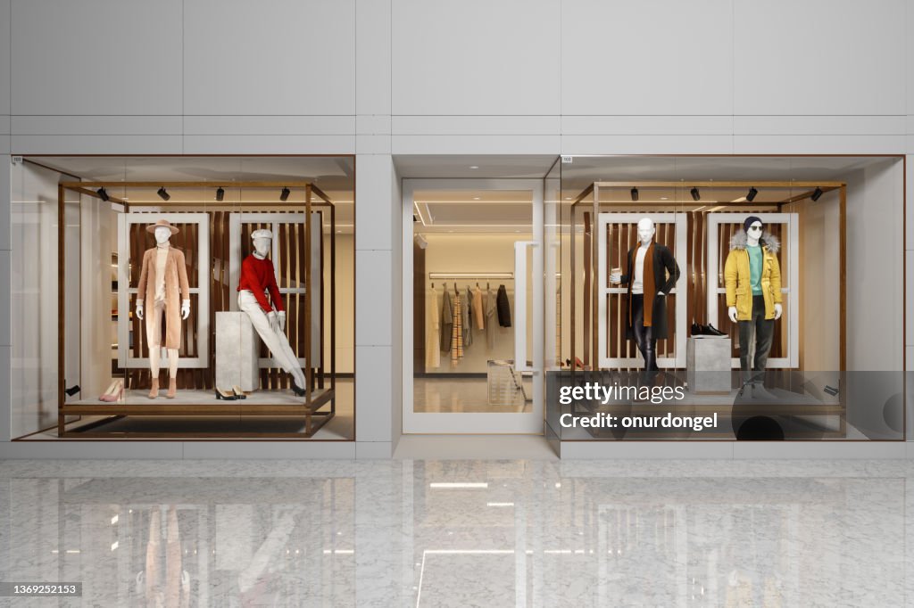 Exterior Of Clothing Store With Women's And Men's Clothing On Mannequins Displaying In Showcase.
