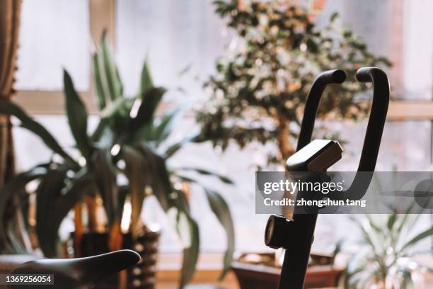 exercise bikes in living  room - daily life in dalian stock pictures, royalty-free photos & images