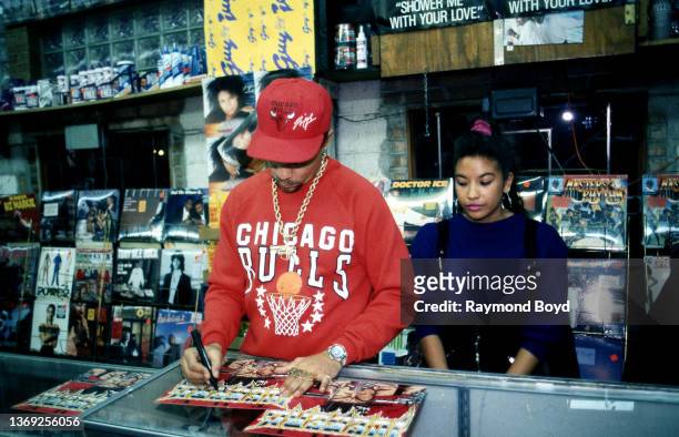 Rapper and actor Ice-T and his girlfriend Darlene Ortiz signs autographs and greets fans at Fletcher's One Stop in Chicago, Illinois in October 1989.