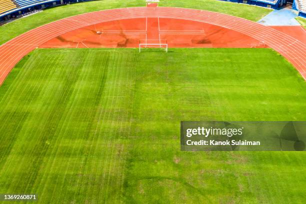 aerial view of sports venue with soccer field and running track. - big sports event stock pictures, royalty-free photos & images