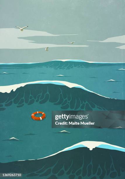 life ring floating over choppy ocean between stormy waves - lifesaver stock illustrations