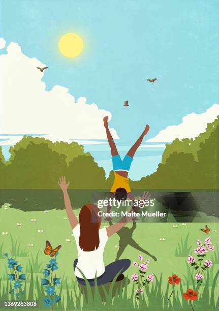 woman cheering for man doing handstand in sunny, idyllic springtime meadow - handstand stock illustrations