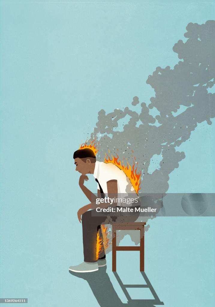 Businessman with back, legs and head on fire