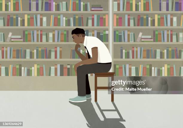 thoughtful boy in shirt and tie sitting by bookcases in library - hand on chin stock illustrations