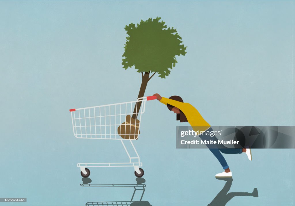 Girl pushing heavy shopping cart with tree sapling