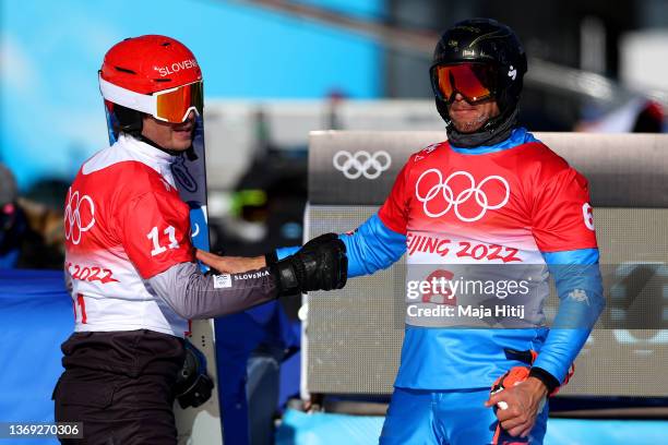 Roland Fischnaller of Team Italy and Zan Kosir of Team Slovenia compete during the Men's Parallel Giant Slalom 1/8 Finals on Day 4 of the Beijing...