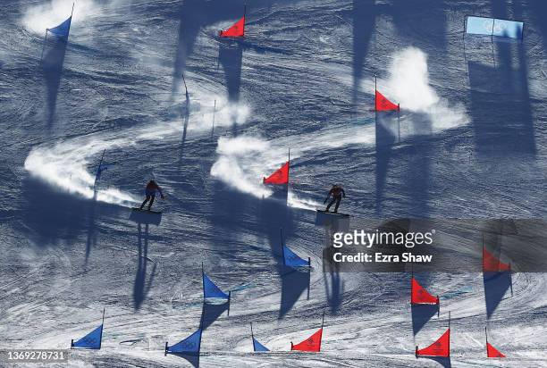 Roland Fischnaller of Team Italy and Benjamin Karl of Team Austria compete during the Men's Parallel Giant Slalom Semifinals on Day 4 of the Beijing...