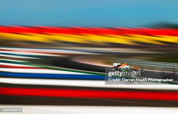 German Force India Formula One team racing driver Adrian Sutil driving his VJM06 racing car at speed around Turn 11 of the circuit and alongside...