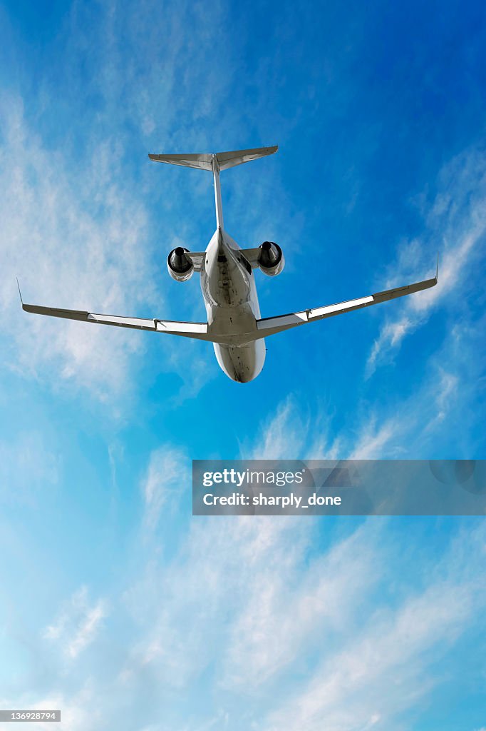 XXL corporate jet airplane flying in bright sky