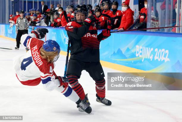 Akane Hoyosamada of Team Japan challenges checks Daniela Pejsova of Team Czech Republic in the first period during the Women's Preliminary Round...