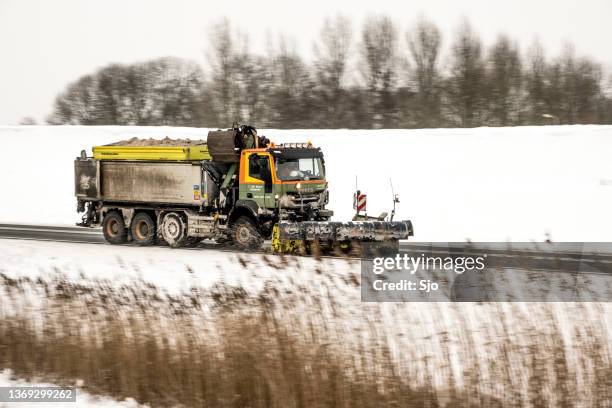 winter service vehicle truck with snow plow clearing the roads of snow and ice - snow plow stock pictures, royalty-free photos & images