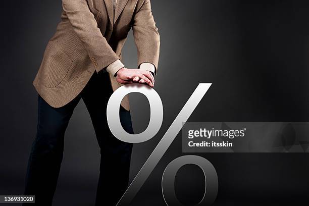 pushing down interest rate - percentage sign stock pictures, royalty-free photos & images