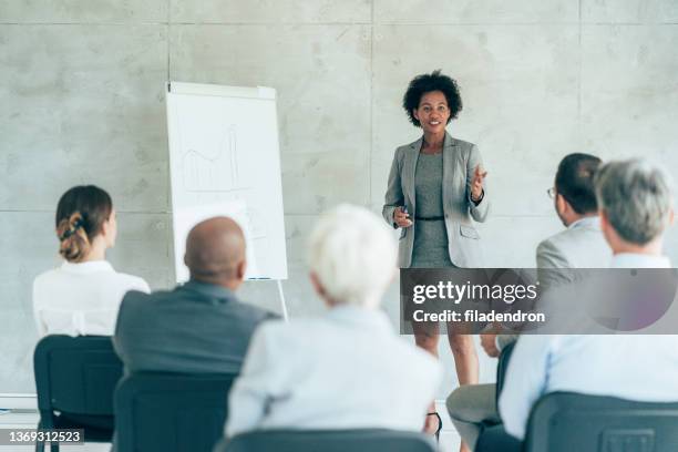 business seminar - woman presenter stock pictures, royalty-free photos & images