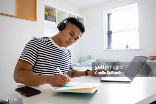 focused on his education - writer desk stock pictures, royalty-free photos & images