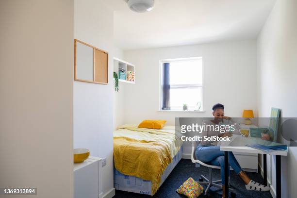 relaxing in her university dorm - dorm room stock pictures, royalty-free photos & images