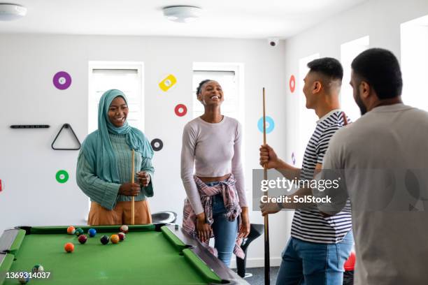students playing pool at the weekend - pool table stock pictures, royalty-free photos & images