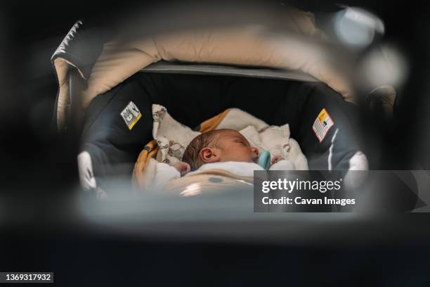 newborn baby sleeping in his carriage. - cochecito de bebé fotografías e imágenes de stock