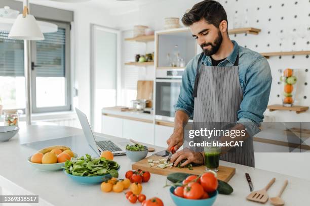 young handsome man in the kitchen - young man groceries kitchen stock pictures, royalty-free photos & images