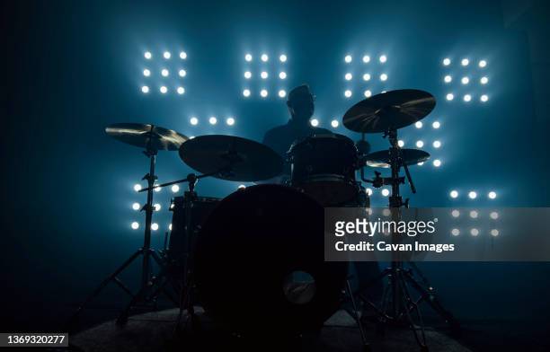 drummer performing in front of audience blinder - drum kit stock pictures, royalty-free photos & images