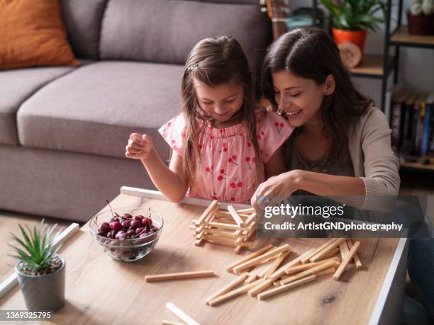 family games unites the family members - jenga stock pictures, royalty-free photos & images