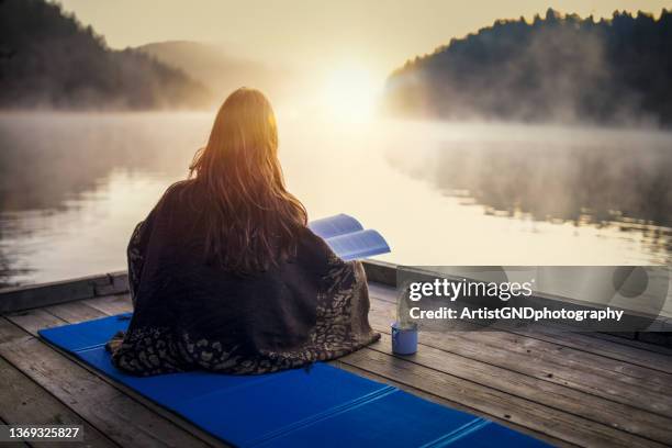 woman relaxing with book and coffee on sunrise. - twilight book stock pictures, royalty-free photos & images