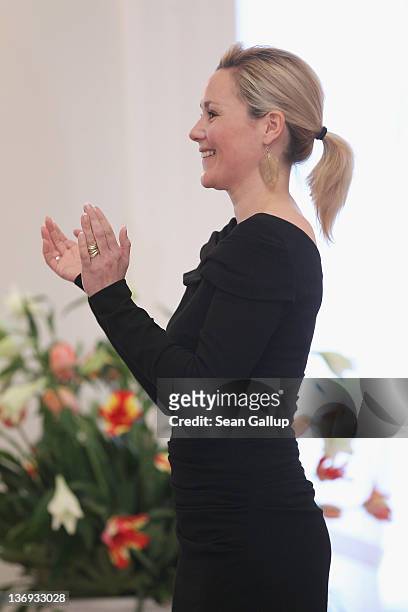German First Lady Bettina Wulff listens to a children's choir perform at her annual reception for foreign diplomats' spouses at Schloss Bellevue...