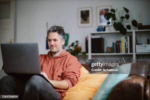 computer programmer doing work from home - using laptop at home happy copy space stock pictures, royalty-free photos & images
