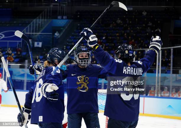 Forward Michelle Karvinen of Team Finland celebrates her goal with forward Petra Nieminen of Team Finland and forward Susanna Tapani of Team Finland...