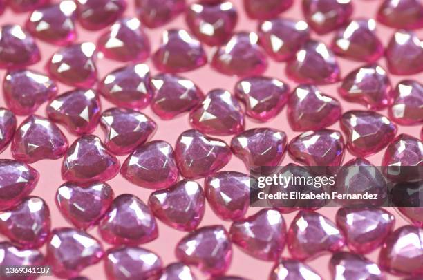 pink heart gems on pink background - rhinestone stock pictures, royalty-free photos & images