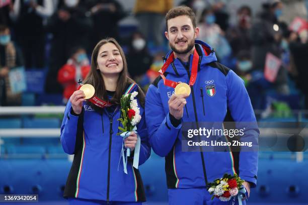 Gold medallists Stefania Constantini and Amos Mosaner of Team Italy pose with their medals during the Curling Mixed Doubles medal ceremony on Day 4...