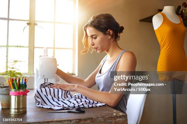 id rather be sewing a young designer making a garment in her - peopleimages stock-fotos und bilder