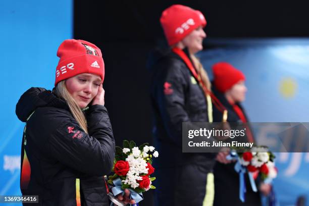 Silver medallist Anna Berreiter of Team Germany wipes away tears during the Women's Singles Luge medal ceremony on day four of the Beijing 2022...