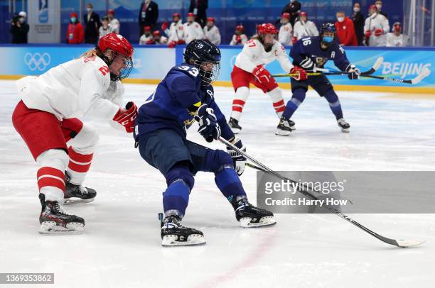 Forward Michelle Karvinen of Team Finland skates past defender Angelina Goncharenko of Team ROC in the third period during the Women's Preliminary...