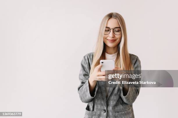 a student in casual clothes prints an online message and does online shopping using a mobile phone and wireless technology on a white background. a business woman in a jacket communicates using a smartphone. online education . millennial life - life jacket isolated stock pictures, royalty-free photos & images
